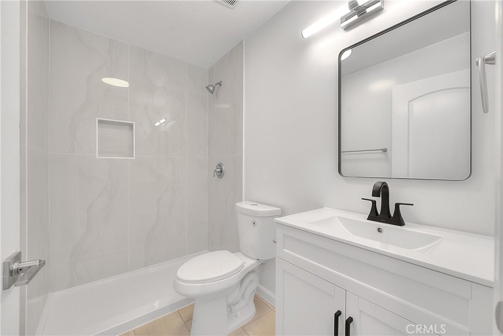 3105 Walton Avenue Los Angeles, CA 90007 - Photo 31 of 38 a bathroom with a sink a toilet a mirror and shower