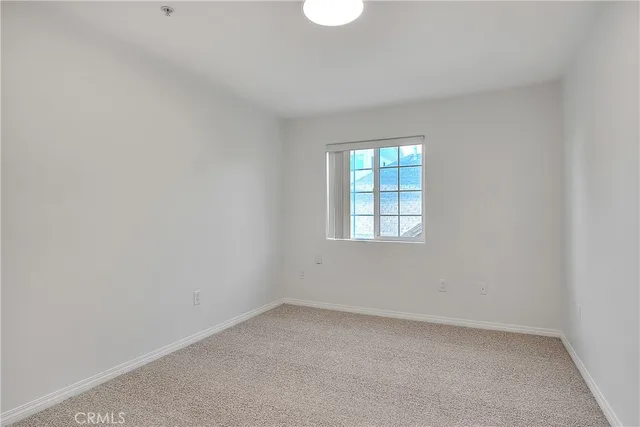 an empty room with windows and wooden floor