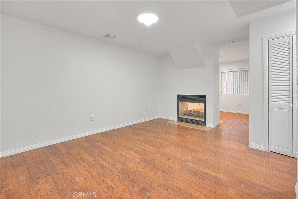 3105 Walton Avenue Los Angeles, CA 90007 - Photo 7 of 38 a view of empty room with wooden floor and windows