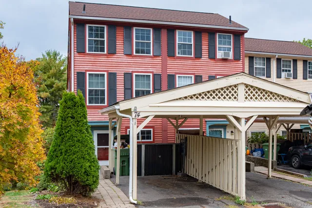 a view of a house with a garage and balcony