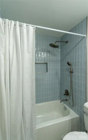 a bathroom with a shower curtain and a bathtub