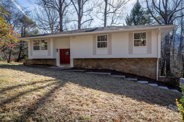 a view of a house with a yard covered in the snow