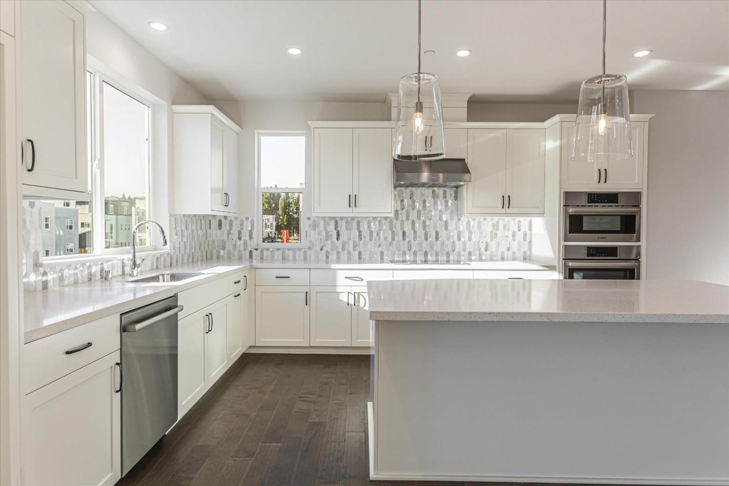 7021 Sunglow Terrace San Ramon, CA 94583 - Photo 7 of 16 a kitchen with stainless steel appliances kitchen island a large island in the center and windows
