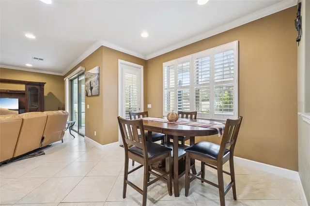 a view of a dining room with furniture and window