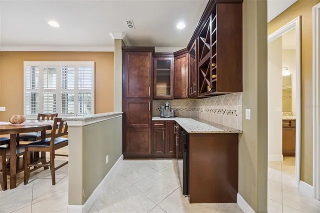 a bed sitting in a bedroom next to a window and a chandelier