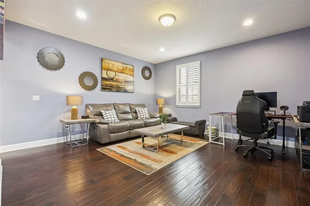 a bedroom with a bed wooden floor and window