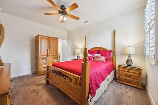 a bedroom with a bed dresser and window