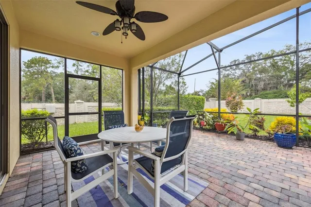 a dining room with furniture a floor to ceiling window and a chandelier
