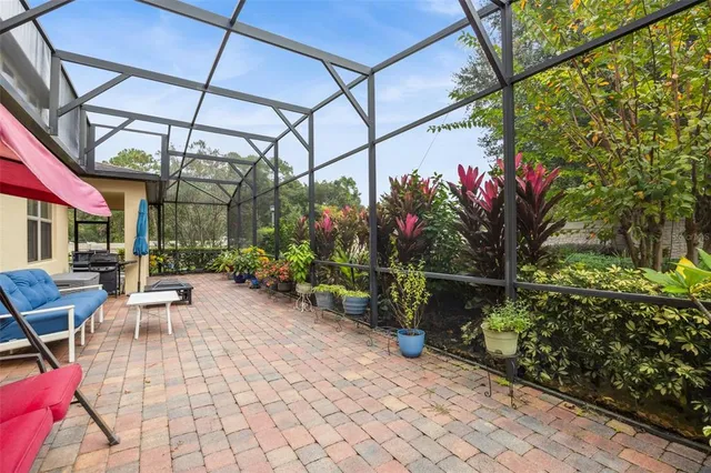 a view of a pathway with a table and chairs under an umbrella
