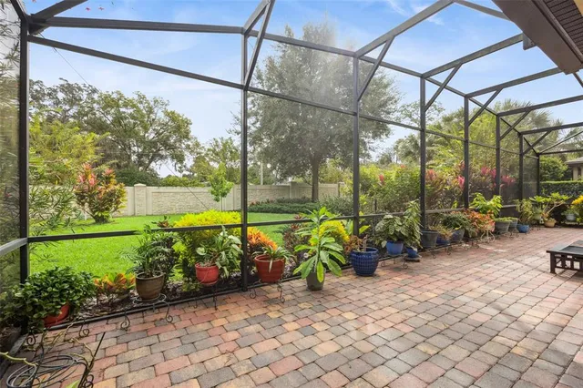 a front view of a house with a big yard and potted plants