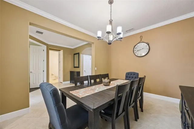a view of a dining room with furniture and chandelier