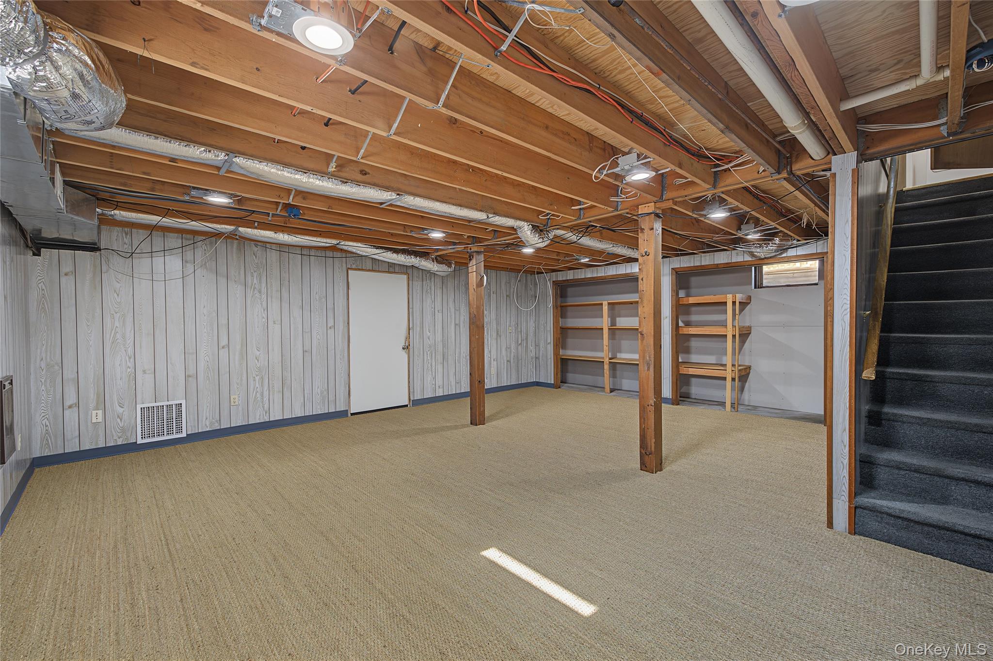 318 Cornwall Hill Road Patterson, NY 12563 - Photo 3 of 38 Spacious lower level featuring light-colored carpeting, paneled walls, exposed ceiling joists, and recessed lighting