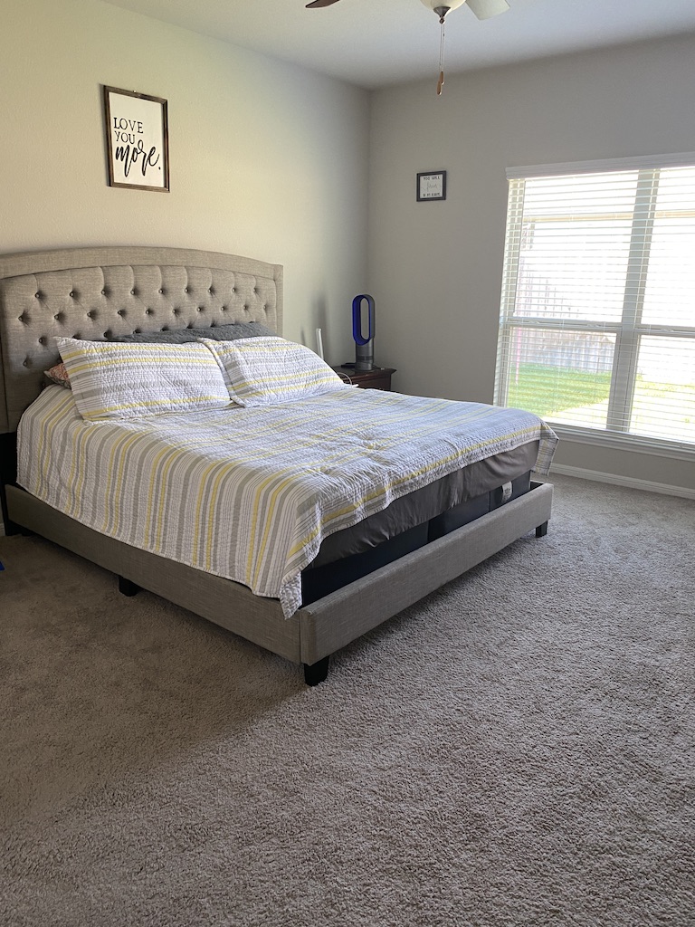 2034 Brisbane Way Bryan, TX 77807 - Photo 13 of 26 a large bed sitting in a bedroom next to a window