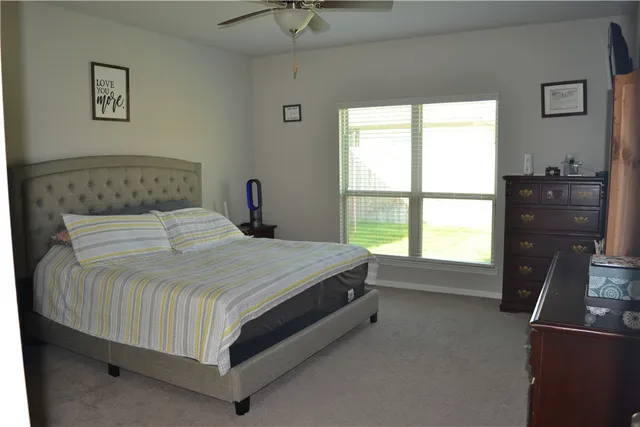 a bed sitting in a bedroom next to a window