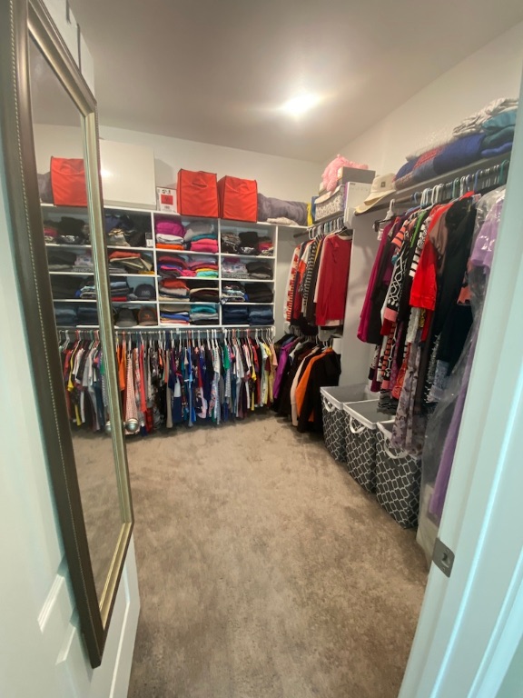 2034 Brisbane Way Bryan, TX 77807 - Photo 21 of 26 a view of walk in closet with clothes and shoes