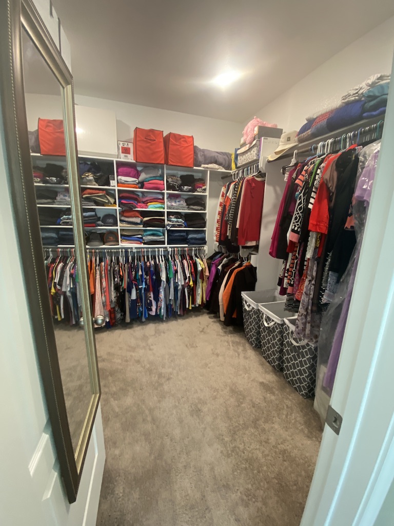 2034 Brisbane Way Bryan, TX 77807 - Photo 21 of 26 a view of walk in closet with clothes and shoes