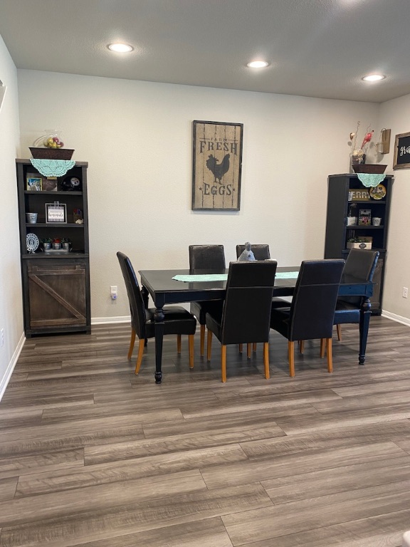 2034 Brisbane Way Bryan, TX 77807 - Photo 6 of 26 a view of a dining room with furniture and wooden floor