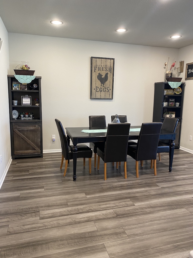 2034 Brisbane Way Bryan, TX 77807 - Photo 6 of 26 a view of a dining room with furniture and wooden floor