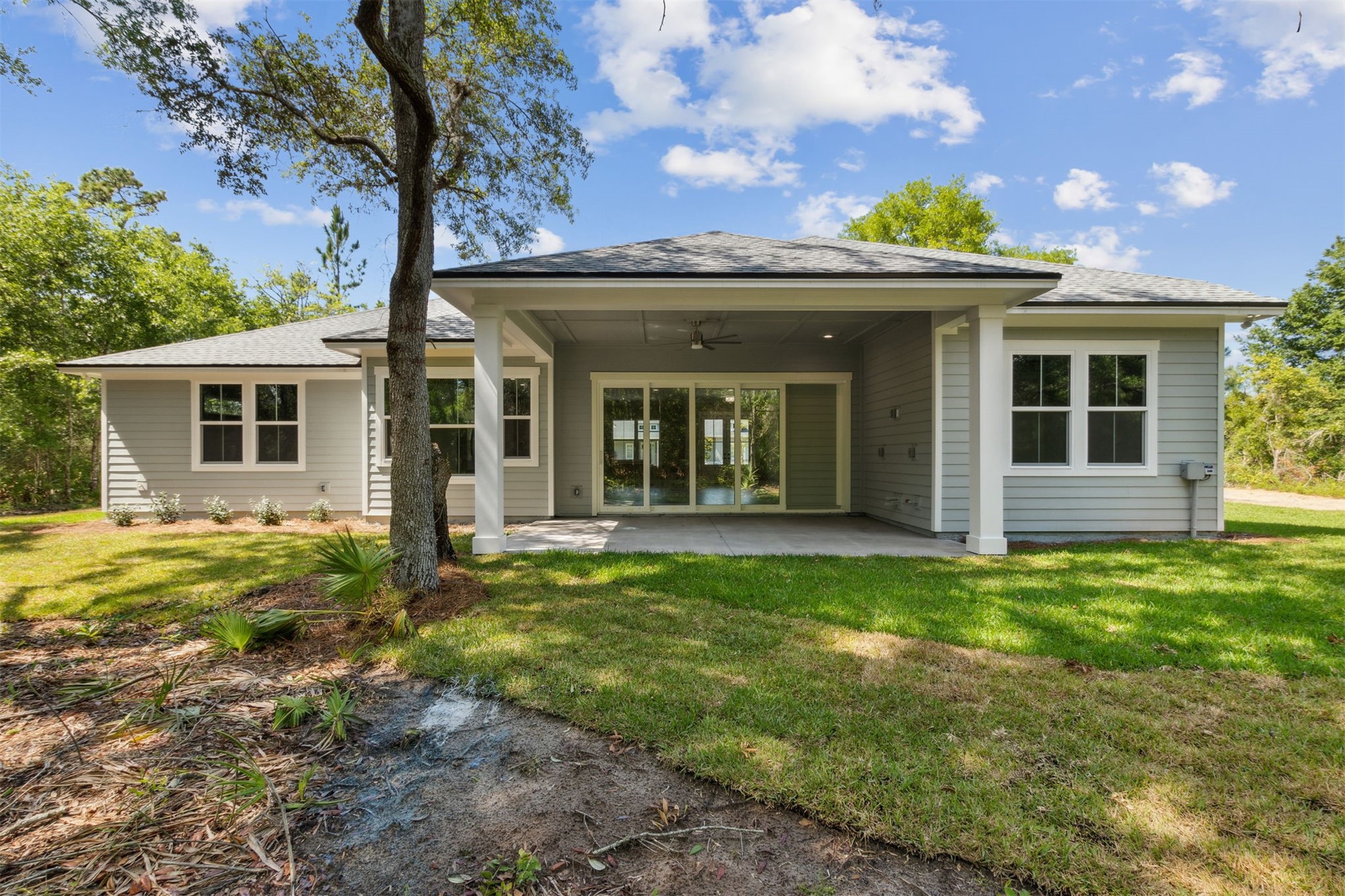 96050 Captains Pointe Road Yulee, FL 32097 - Photo 34 of 36 a view of a house with backyard and a tree