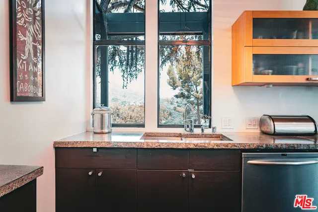 a kitchen with granite countertop a sink and a window
