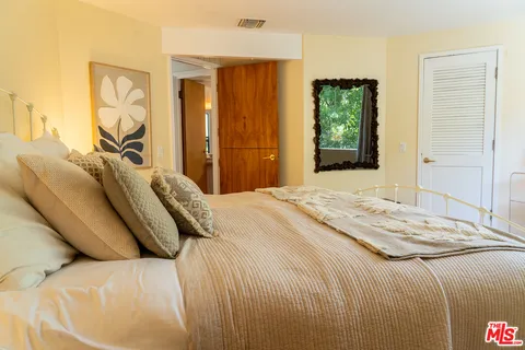 a bedroom with a bed and a lamp