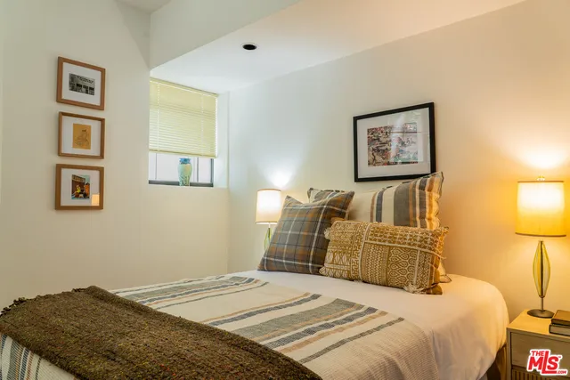 a bedroom with a bed and a painting on the wall