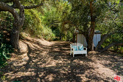 a view of a backyard with chairs