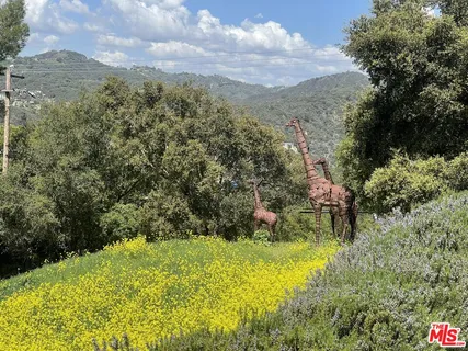 a view of a balcony with table and chairs