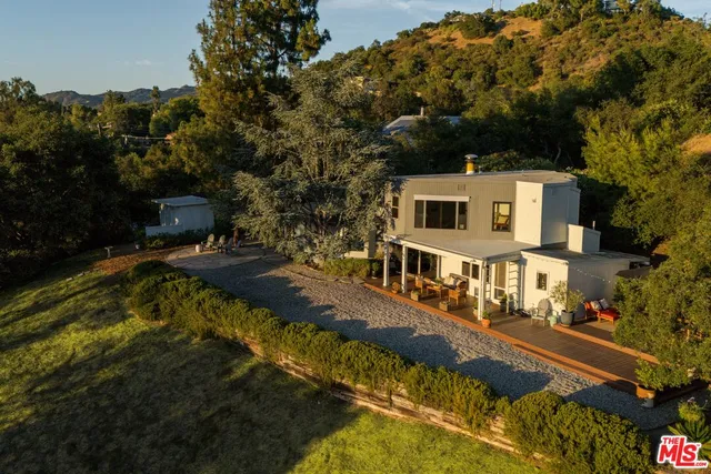 a view of yard with swimming pool and trees in the background