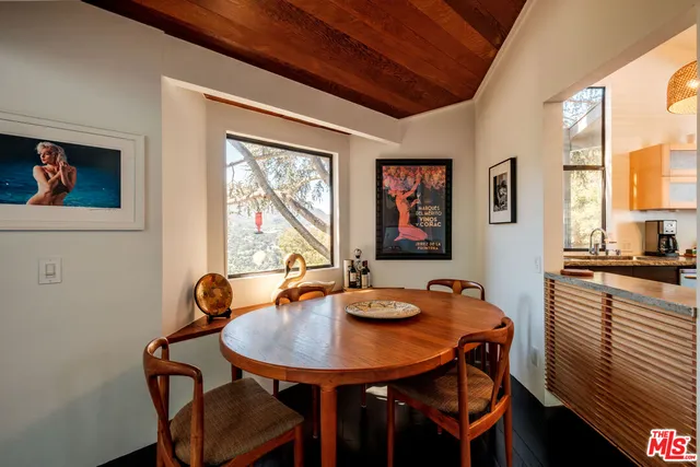 a view of a dining room with furniture and window