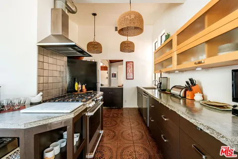 a kitchen with stainless steel appliances granite countertop a stove and a sink