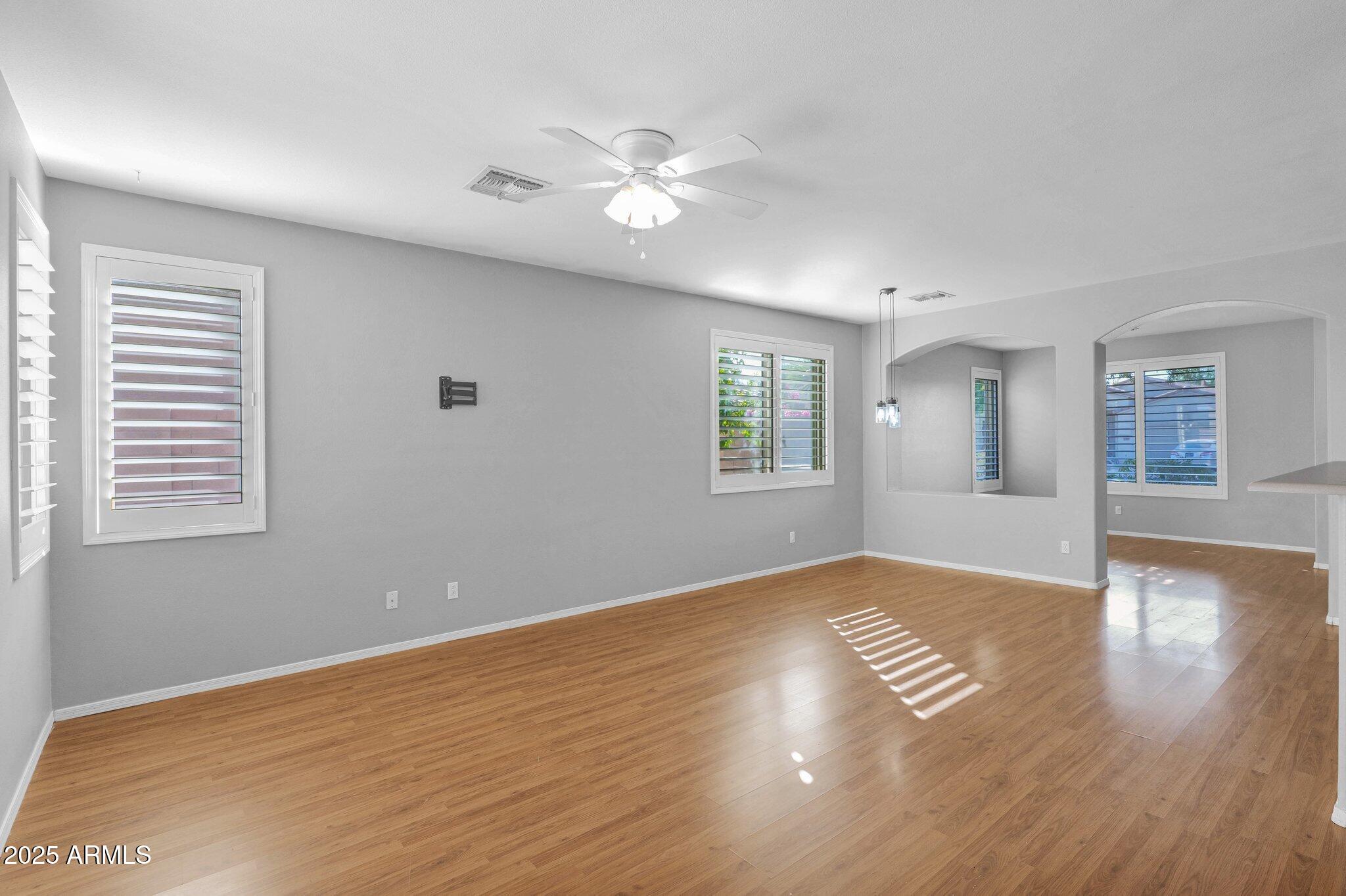 2190 East Augusta Avenue Chandler, AZ 85249 - Photo 11 of 35 a view of an empty room with wooden floor and a window
