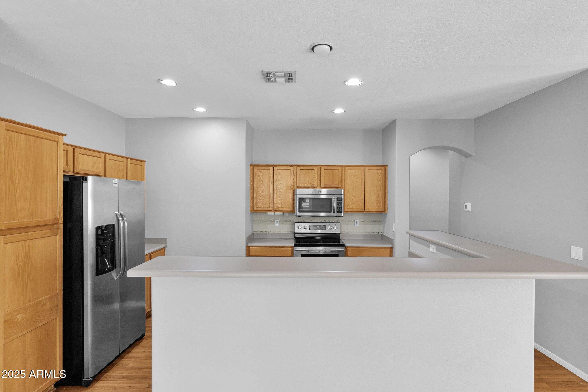 2190 East Augusta Avenue Chandler, AZ 85249 - Photo 12 of 35 a kitchen with stainless steel appliances a refrigerator sink and stove