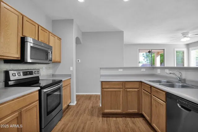 a kitchen with a sink stove and microwave