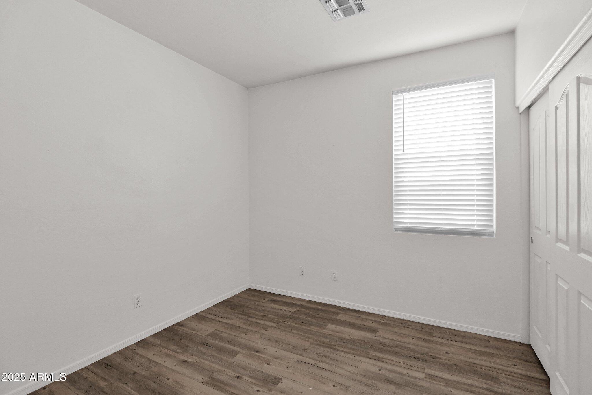 2190 East Augusta Avenue Chandler, AZ 85249 - Photo 16 of 35 an empty room with wooden floor and windows