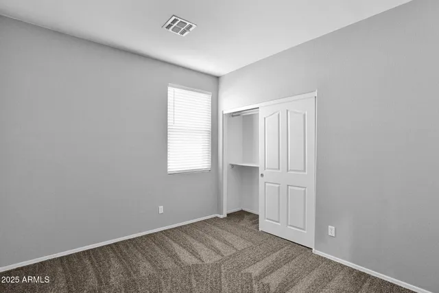 an empty room with closet area