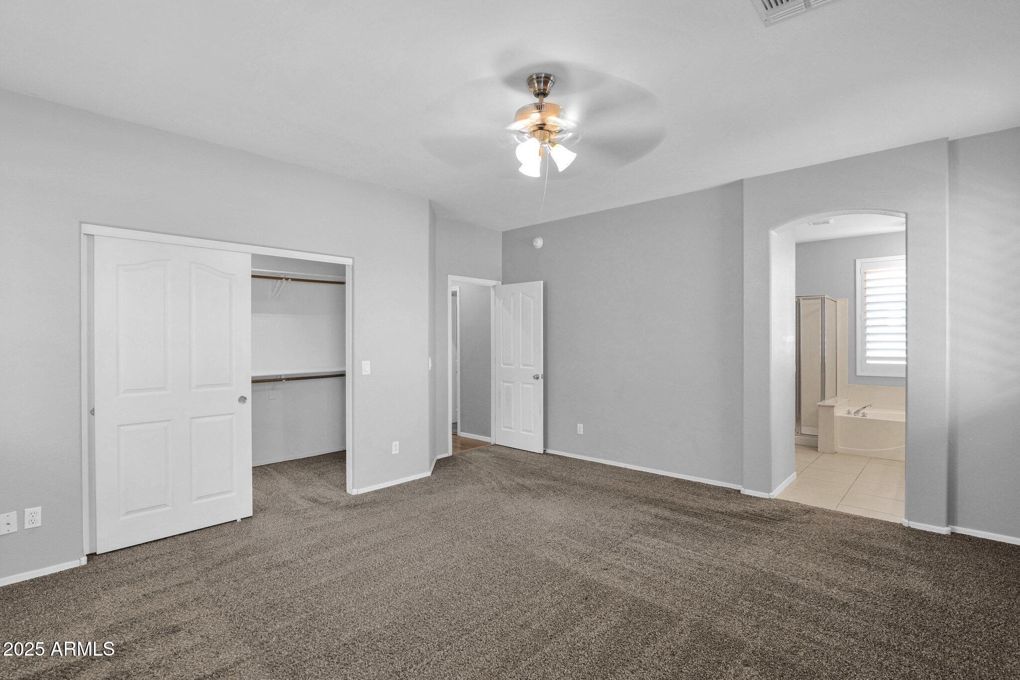 2190 East Augusta Avenue Chandler, AZ 85249 - Photo 22 of 35 a view of an empty room with a chandelier fan