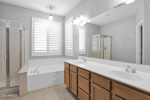 a bathroom with a tub sink and mirror