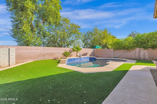 a view of a backyard with swimming pool