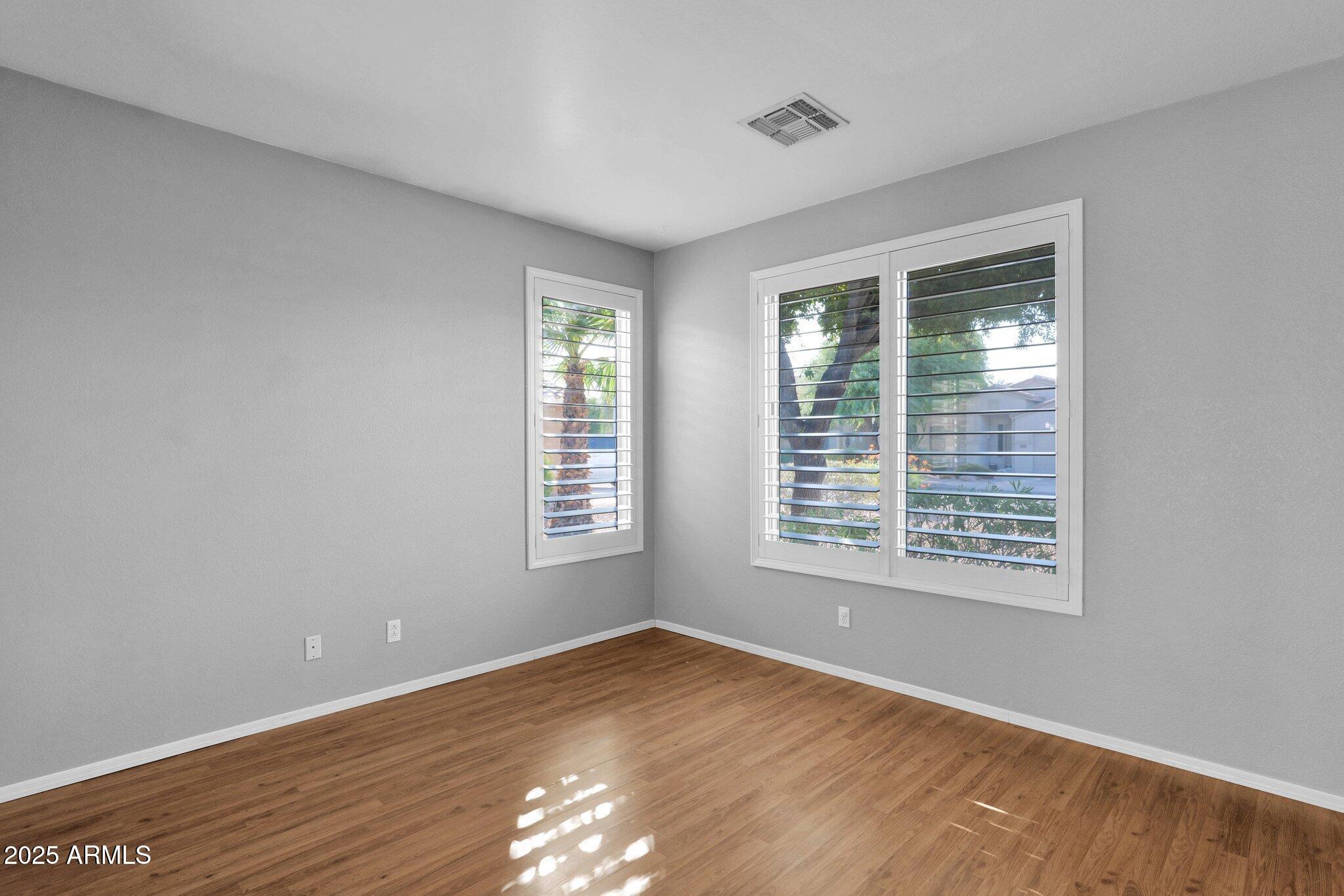 2190 East Augusta Avenue Chandler, AZ 85249 - Photo 6 of 35 a view of an empty room with wooden floor and a window