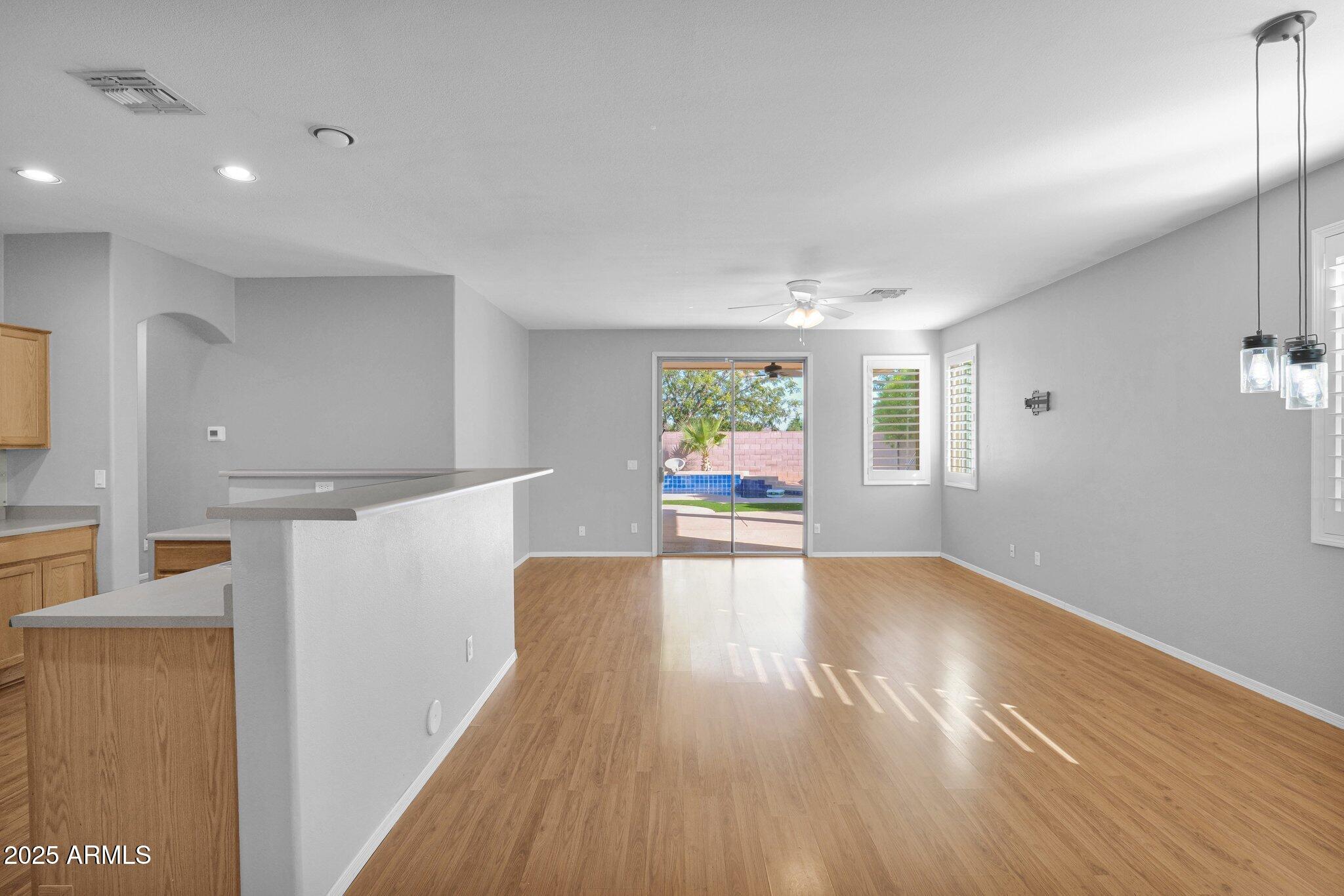 2190 East Augusta Avenue Chandler, AZ 85249 - Photo 7 of 35 a view of an empty room with window and wooden floor