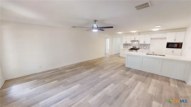 a view of a kitchen with marble kitchen counter top space a sink and dishwasher