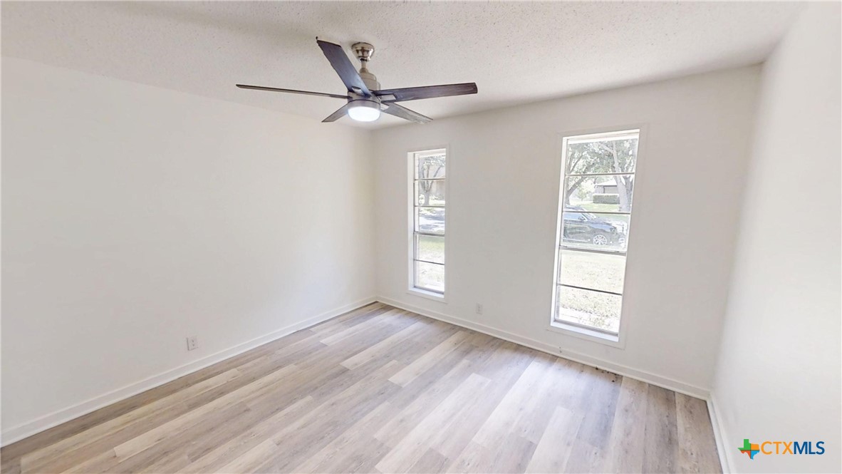 4118 Ermine Trail Temple, TX 76504 - Photo 19 of 31 an empty room with windows and fan