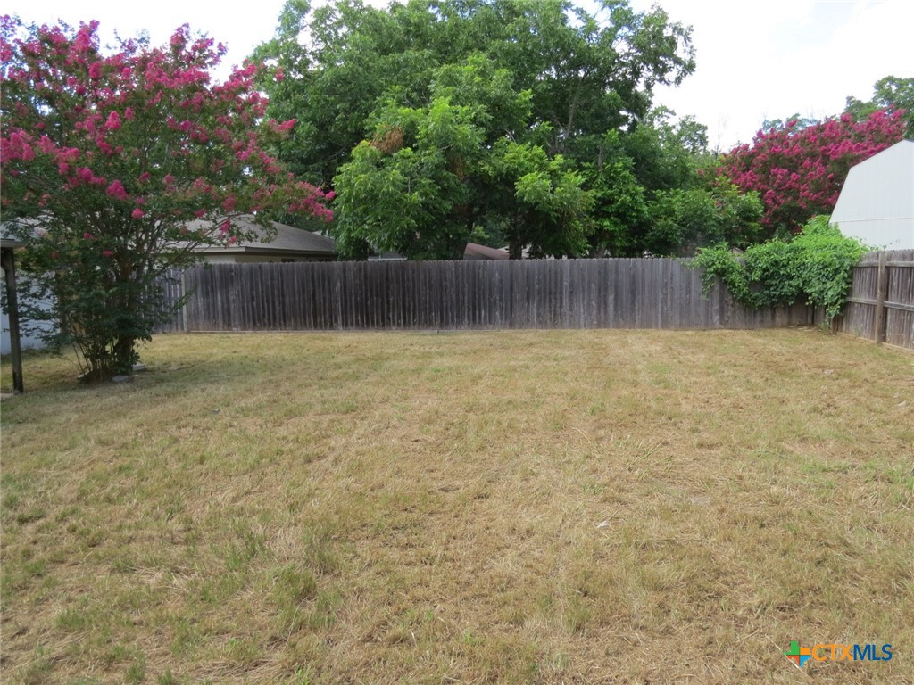 4118 Ermine Trail Temple, TX 76504 - Photo 31 of 31 a backyard of a house with lots of green space and wooden fence
