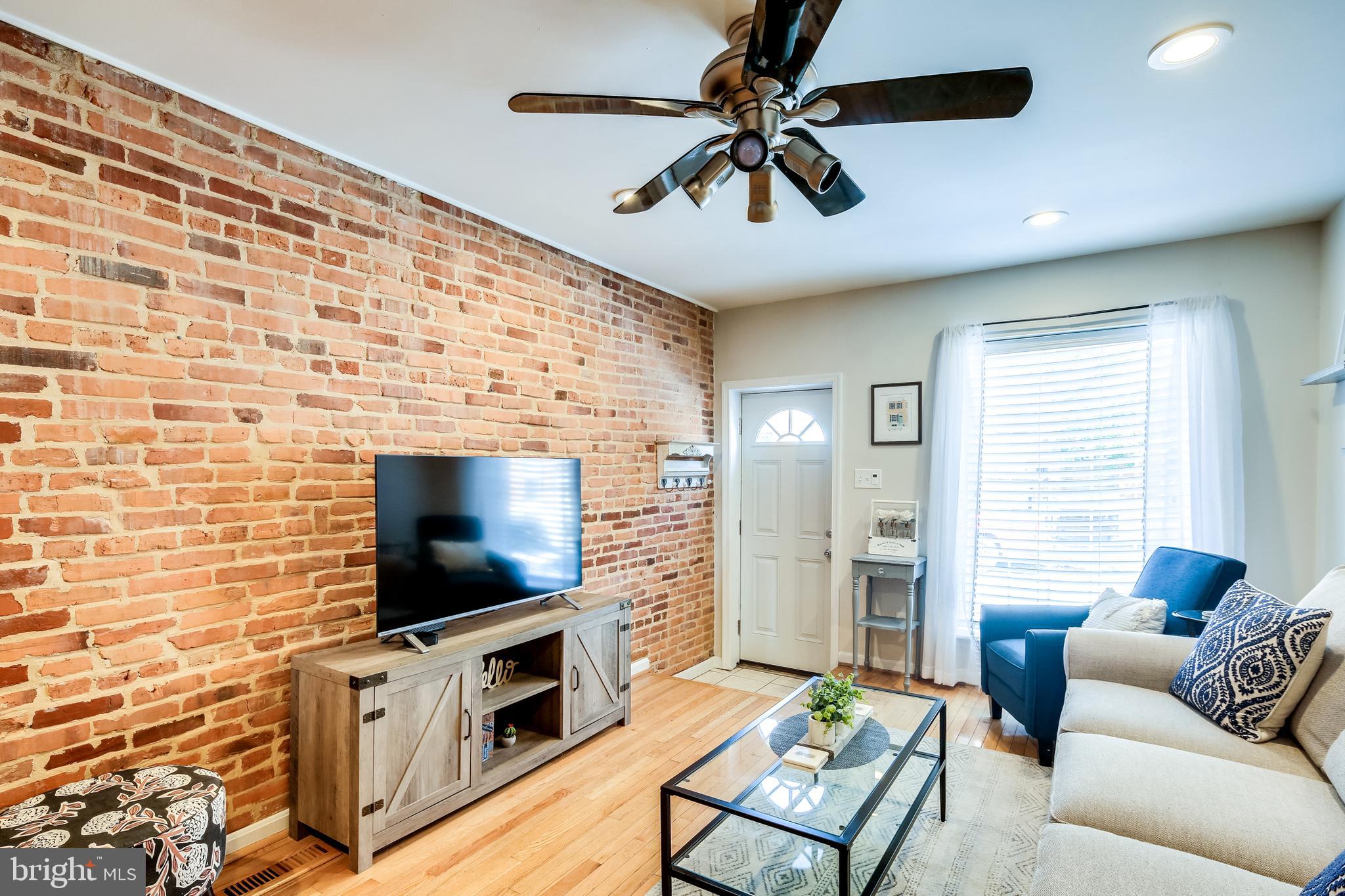 728 South Curley Street Baltimore, MD 21224 - Photo 5 of 29 Living Room with Exposed Brick