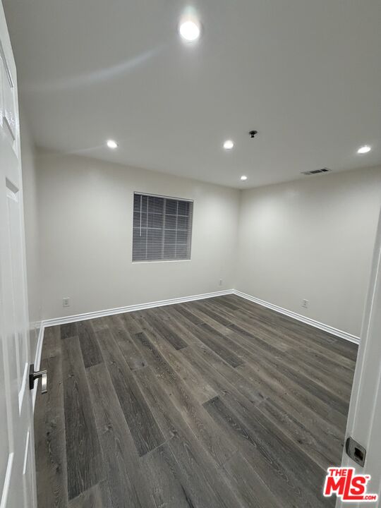 121 South Rampart Boulevard, Unit 3 Los Angeles, CA 90057 - Photo 14 of 20 an empty room with wooden floor and window