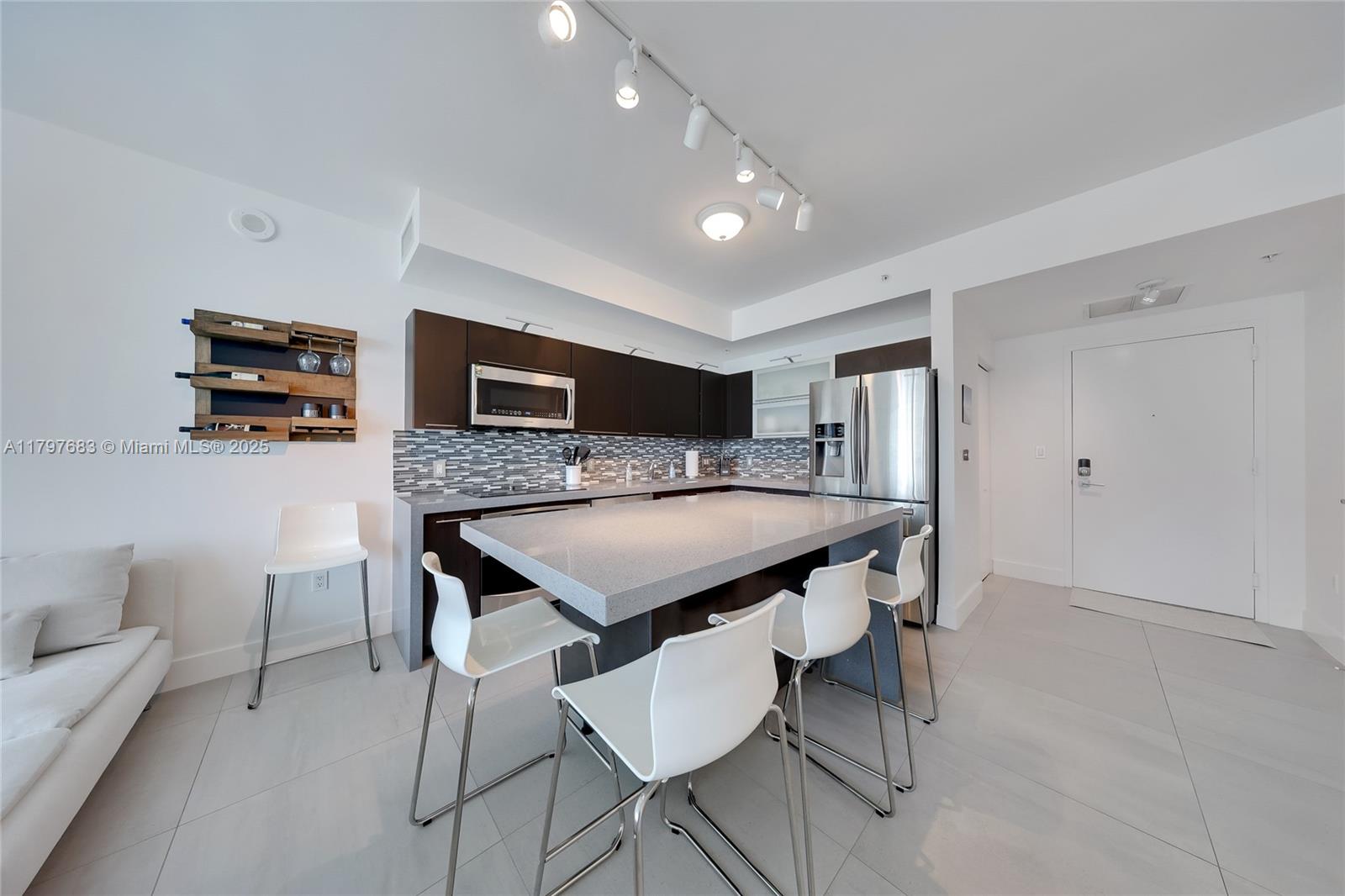 a kitchen that has a table and chairs in it