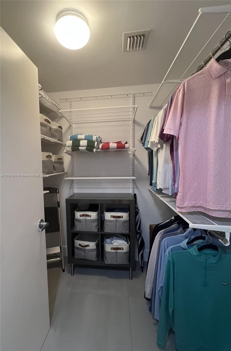 90 Southwest 3rd Street, Unit 1514 Miami, FL 33130 - Photo 12 of 25 a view of walk in closet with clothes and shoes