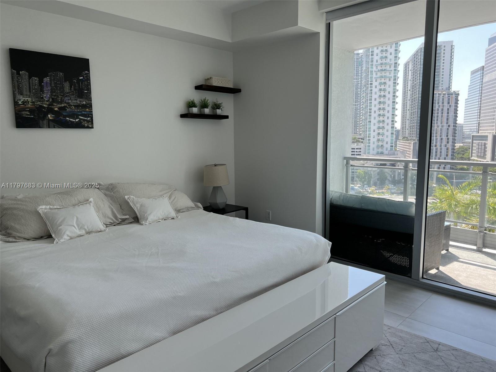 90 Southwest 3rd Street, Unit 1514 Miami, FL 33130 - Photo 17 of 25 a bedroom with a bed and a window