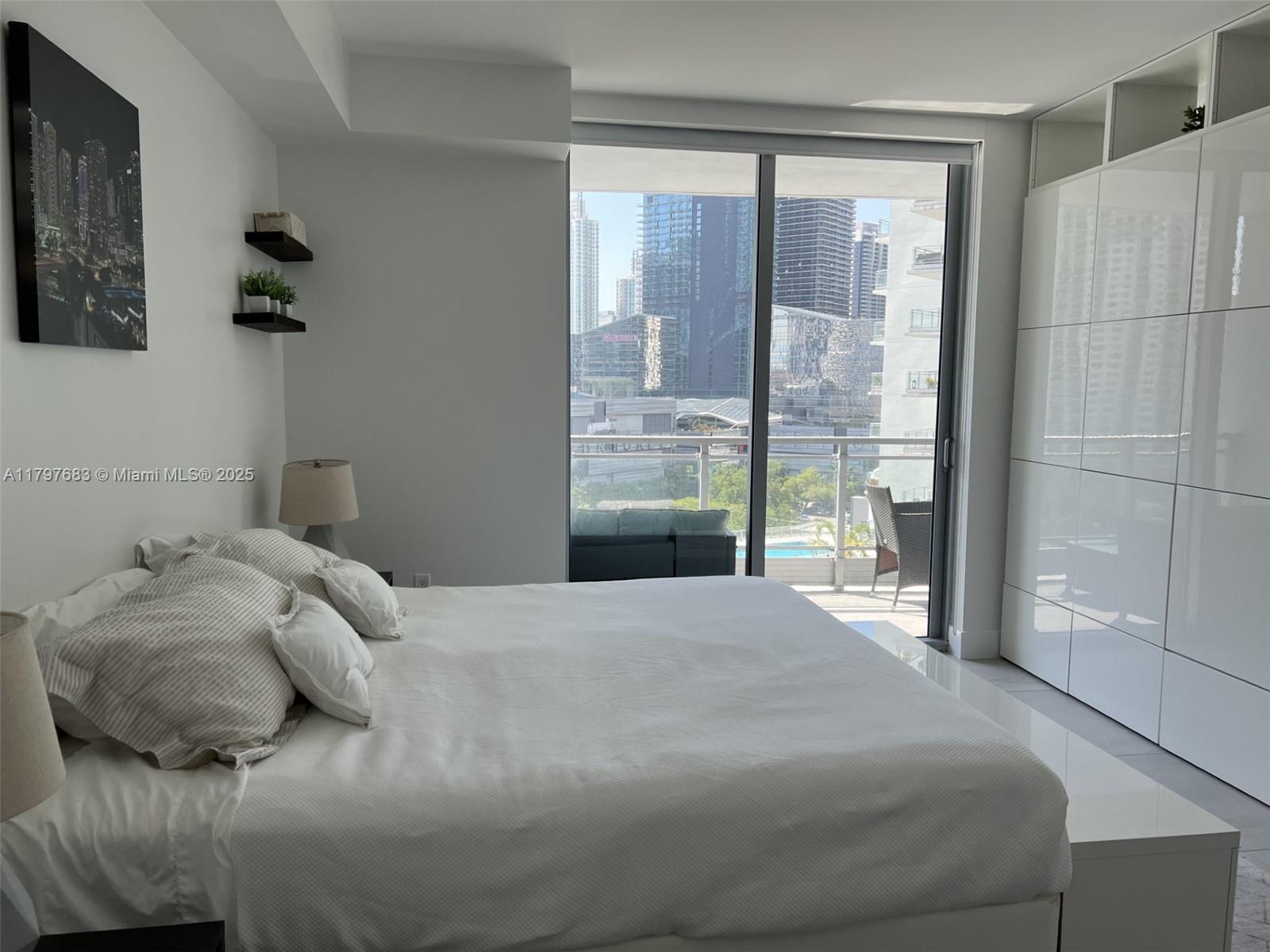 90 Southwest 3rd Street, Unit 1514 Miami, FL 33130 - Photo 19 of 25 a bedroom with a bed and a window